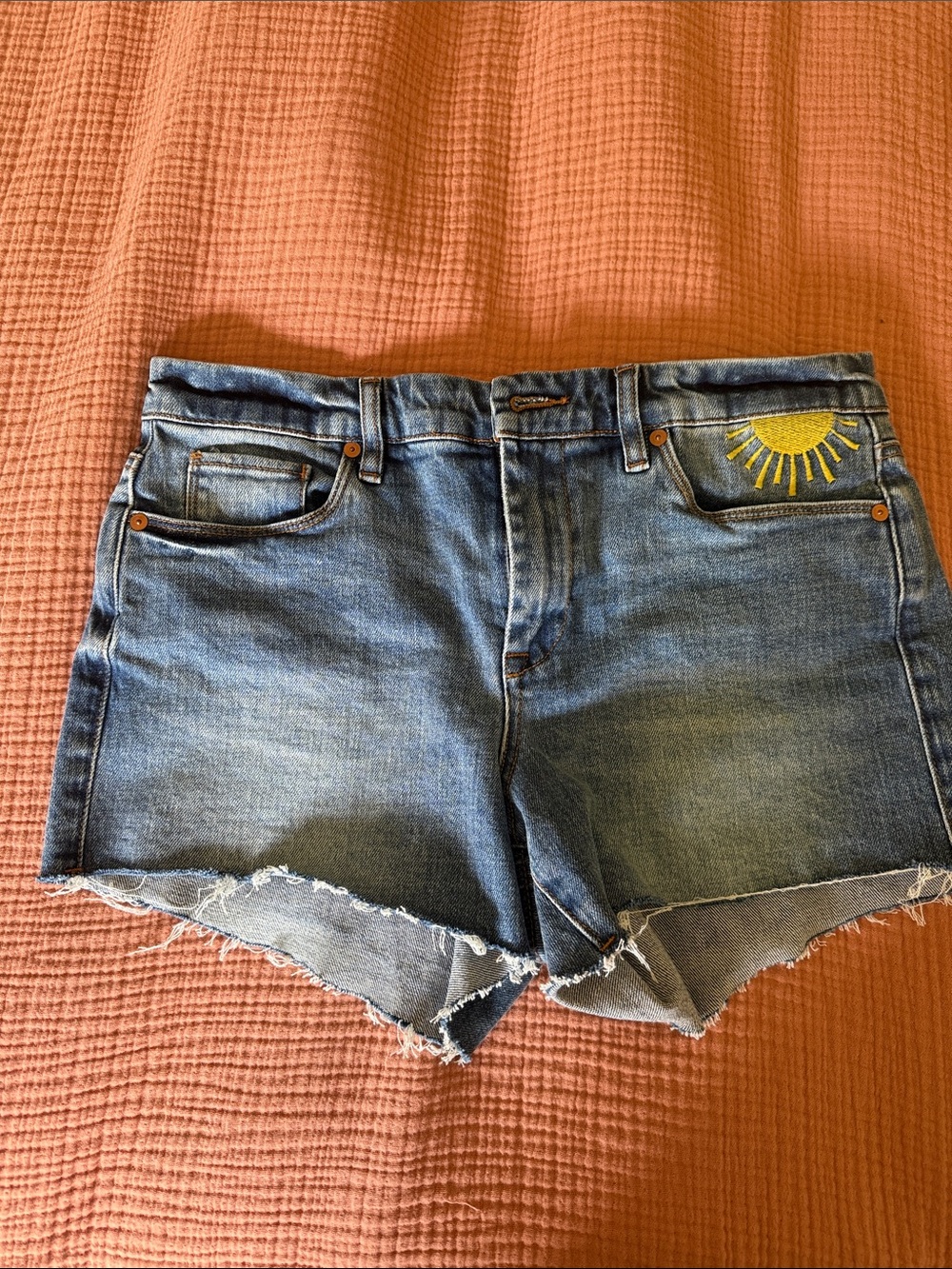 Blank NYC Medium Blue Cutoff Denim Shorts with Yellow Sun Accent